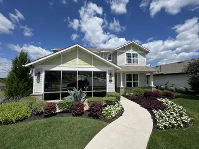 A charming two-story home with a manicured lawn in Cloverleaf by Brohn Homes (Austin, TX). A charming two-story home with a manicured lawn in Cloverleaf by Brohn Homes (Austin, TX).