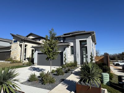 A sleek modern home with clean lines, stone accents, and lush landscaping in Old Town East by Perry Homes (Pflugerville, TX). A sleek modern home with clean lines, stone accents, and lush landscaping in Old Town East by Perry Homes (Pflugerville, TX).