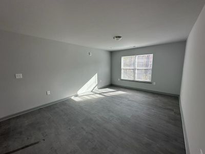 Empty room with hardwood / wood-style flooring