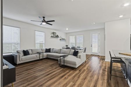 Spacious living room with upgraded ceiling fan!