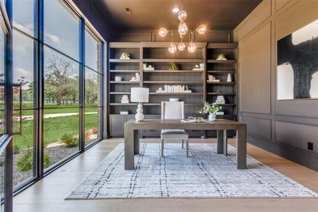 Home office with a notable chandelier, built in features, wood-type flooring, and floor to ceiling windows