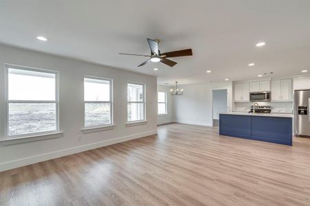 Kitchen featuring light wood-style flooring, white cabinetry, stainless steel appliances, and recessed lighting