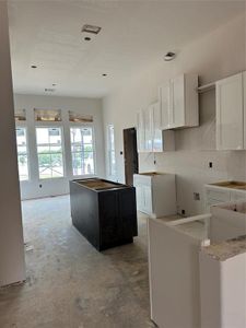 Large kitchen with hanging pot rack, undercounter lights