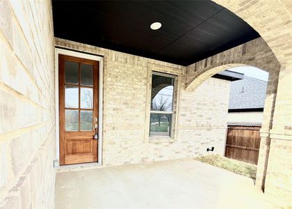 Property entrance featuring brick siding