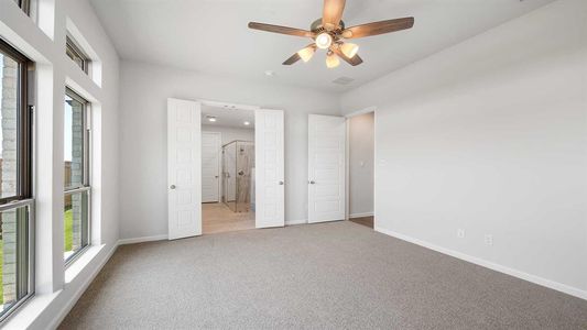 Unfurnished bedroom featuring light colored carpet and ceiling fan