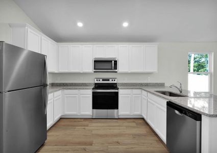 Enjoy stunning granite countertops and designer cabinetry in this kitchen.