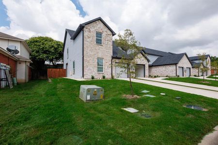 View of front of property with a garage and a front yard