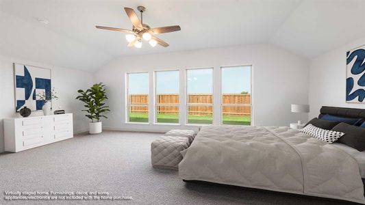 Carpeted bedroom with vaulted ceiling and ceiling fan