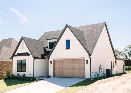 Modern farmhouse featuring cooling unit and a garage