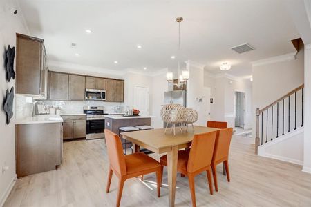 The Coleman- Dining Area into Kitchen. Home under construction. Sample floor plan photo used for illustrative purposes only. Upgrades, selections options, windows and colors may vary.