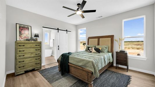 Master bedroom with barn door to the master bath.