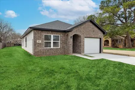 Ranch-style home featuring a garage, brick siding, driveway, roof with shingles, and a front lawn