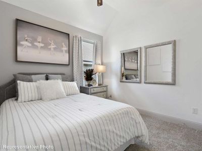 Bedroom featuring carpet flooring and vaulted ceiling