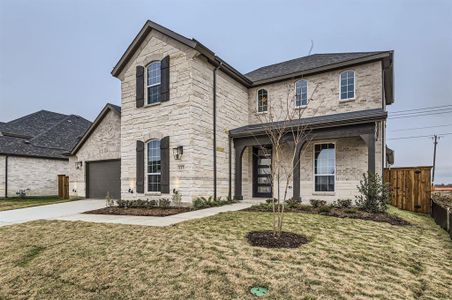 View of front facade with a garage and a front yard