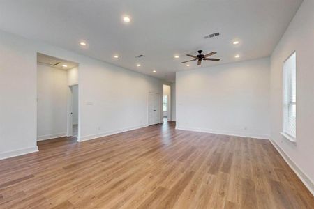 Empty room featuring ceiling fan and light hardwood / wood-style flooring