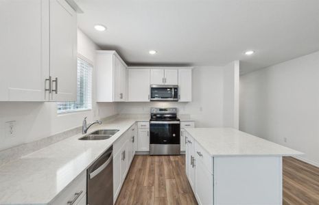 Spacious kitchen with large island *real home pictured