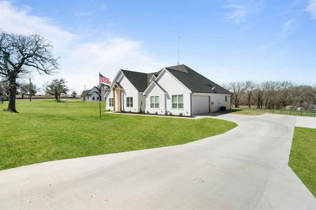 View of front of house with a front yard and a garage