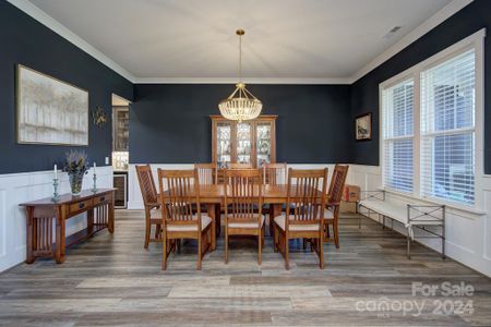 Formal Dining room with craftsman style molding and upgraded lighting from Efirds