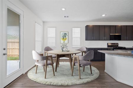 This lovely breakfast area is perfect for starting the day out on the right foot!  This space showcases custom paint, high ceilings, recessed lighting, windows adding to the ample natural light in the kitchen, and vinyl plank flooring!