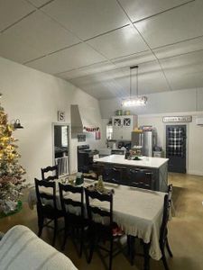 Dining space featuring a drop ceiling and concrete flooring