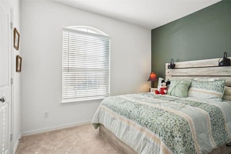 Bedroom featuring carpet and multiple windows