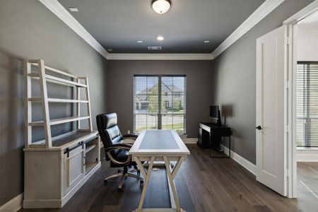 Office area featuring ornamental molding and dark hardwood / wood-style flooring