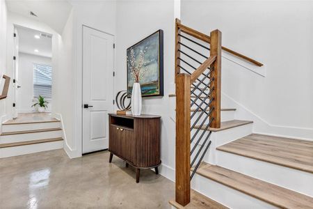 As you enter your new home, you'll see the sleek stained concrete floors and storage space in the coat closet.