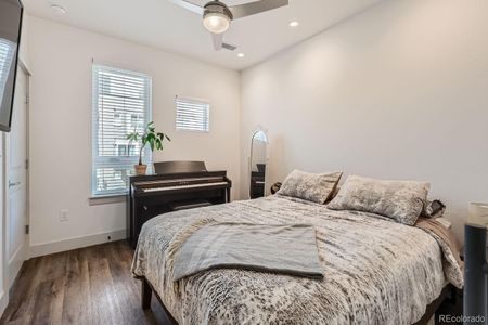 Light filled bedroom with ceiling fan for comfort.