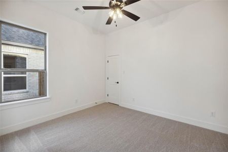 Unfurnished room with carpet, ceiling fan, and a healthy amount of sunlight