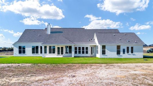 Back of property featuring a lawn