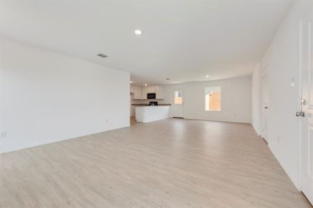 Unfurnished living room featuring light wood-type flooring