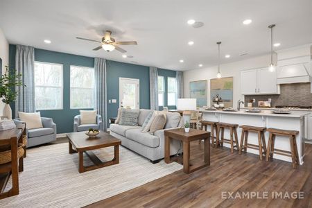 Living room featuring light wood-type flooring, a wealth of natural light, and ceiling fan