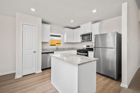 Stainless Steel appliances along with a breakfast bar.