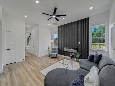 Living room featuring ceiling fan and light hardwood / wood-style floors