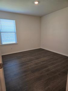 Unfurnished room featuring dark wood-type flooring