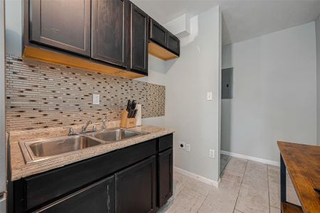 Behind the wall is the tankless water heater as well as washer and dryer connections