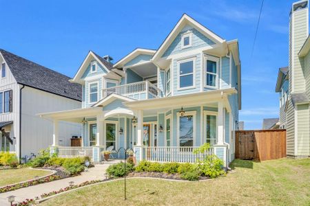 Victorian-style house featuring covered porch, a front yard, and a balcony Victorian-style house featuring covered porch, a front yard, and a balcony