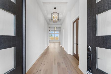 Double Entry Doors Open to Engineered Hardwood Flooring