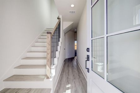 Step inside and be greeted by high ceilings, LED recessed can lighting, soothing paint colors and stylish wood railing with iron spindles on the stairway.