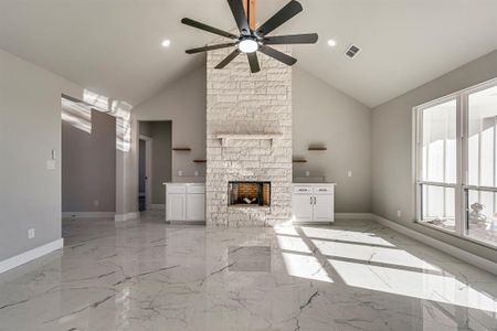 Unfurnished living room featuring marble finish floor, a fireplace, baseboards, and a ceiling fan