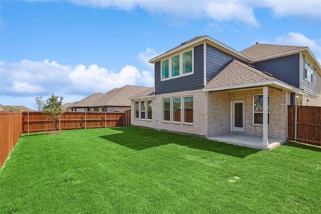 Rear view of house with a lawn and a patio