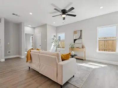 Living room featuring light wood-type flooring and ceiling fan