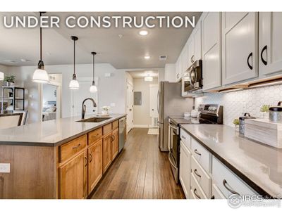 Kitchen w/ large island, ready to personalize. Photos of a previously built model.