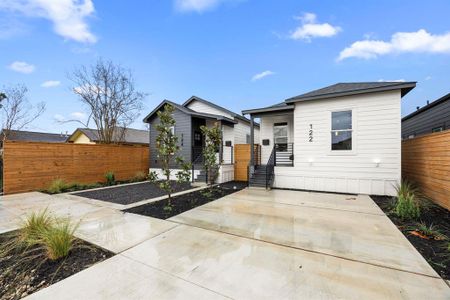 This beautifully designed modern homes features sleek board-and-batten siding, a striking contrast of black and white exteriors, and ample parking, offering both style and functionality in a prime location.