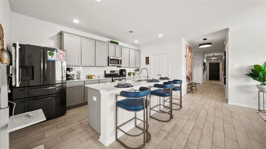 View of kitchen with new appliances, walk in pantry, and leading to the hallway with bedrooms 2-4.