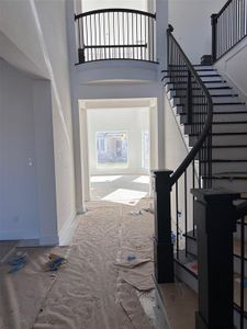 Foyer with dramatic staircase taking shape