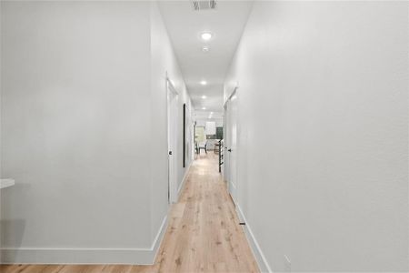 Hallway with light wood-type flooring