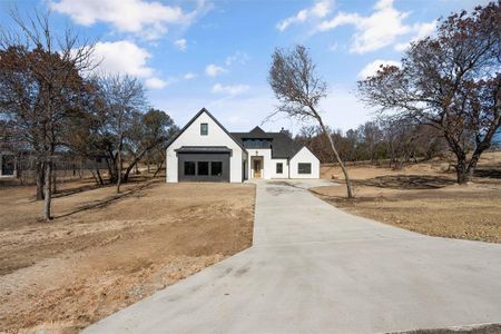 Modern farmhouse style home featuring a garage