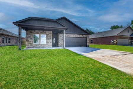 View of front of house with a front yard and a garage