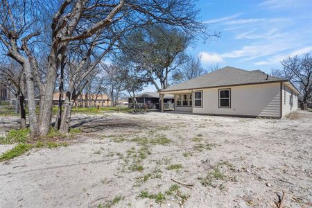 Back of property with a shingled roof